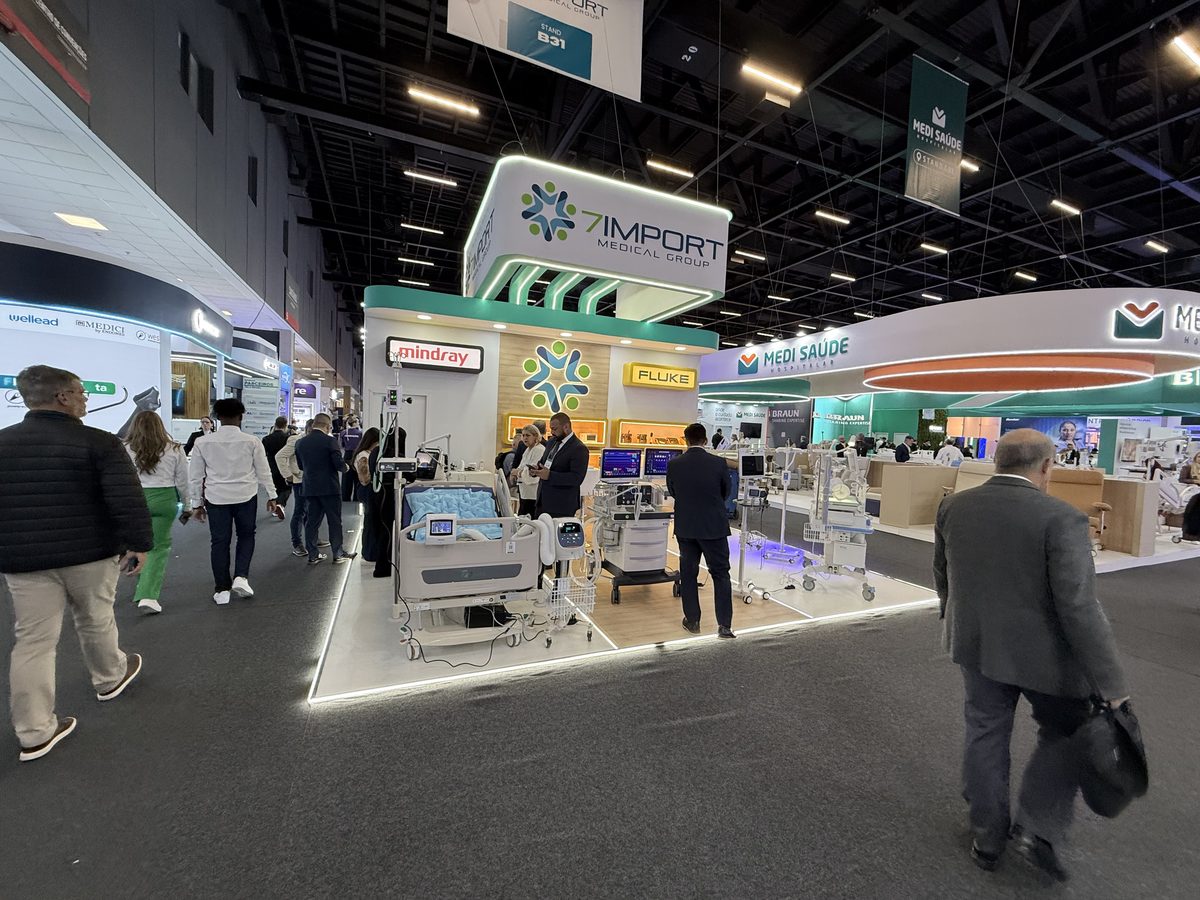 Stand de feira com equipamentos e circulação de visitantes